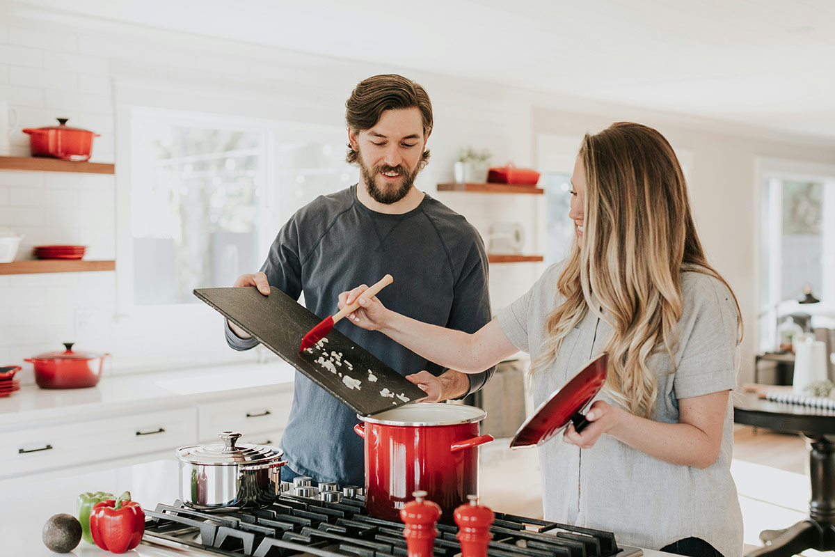 Happy couple cooking in a kitchen